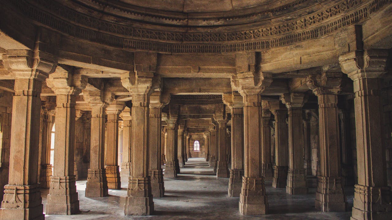 Explore the architectural brilliance of an ancient temples stone columns and arches.